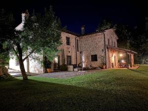 a large stone building with a yard at night at Beautiful Stone Country Villa in Casaprota