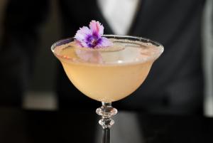 a cocktail with a purple flower in a martini glass at Square Townhouse in Brighton & Hove