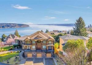 an aerial view of a large house with a lake at Villa Luna in Gig Harbor