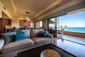 a living room with a couch and a view of the ocean at MAKENA SURF, #C-205 condo in Wailea