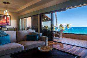 a living room with a couch and a view of the ocean at MAKENA SURF, #C-205 condo in Wailea