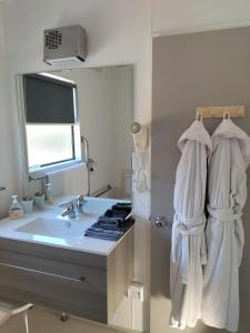 a bathroom with a sink and a mirror at Bay Cottages in Kaikoura