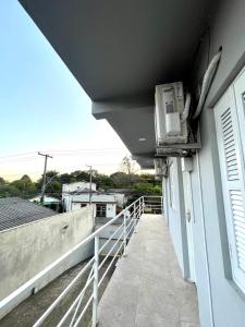 a balcony with a air conditioner on the side of a building at Res Hostel 01 in Santa Cruz do Sul