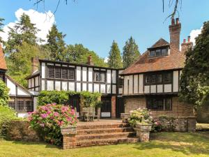 an old house with flowers in the yard at Ridge Hill Manor in Turners Hill