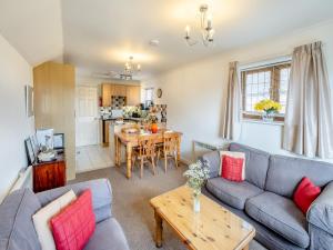 a living room with a couch and a table at Fair Isle Holiday Cottages - Hill Top Cottage in Newport