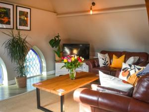 a living room with a couch and a coffee table at Chapel Lodge in Hornsea