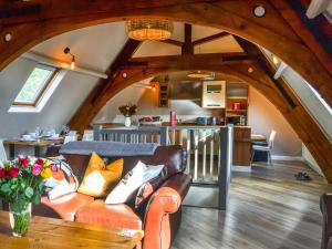 a living room with a couch and a table at Chapel Lodge in Hornsea