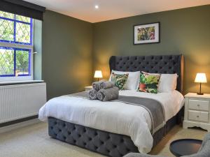 a bedroom with a large bed with two teddy bears on it at Chapel Lodge in Hornsea