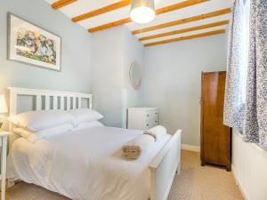 a bedroom with a white bed and a wooden ceiling at Abbots Retreat -uk40757 in Barrow upon Humber