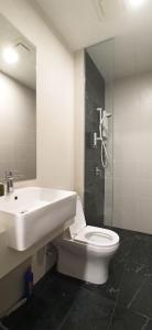 a bathroom with a sink and a toilet and a shower at Beacon Executive Suites George Town Apartment Malaysia deals in George Town