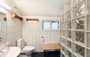 a white bathroom with a toilet and a sink at Awesome Home In yer With House A Mountain View in Øyer