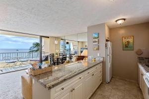 a large kitchen with a view of the ocean at Sugar Beach Resort 531- Direct oceanfront gem at Sugar Beach Resort in Kihei