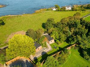 an aerial view of a house on a hill next to the water at Orchard Cabin-rowan - Uk45435 in Isle of Whithorn