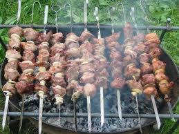 a bunch of meat cooking on a grill at Tako's house in Mestia
