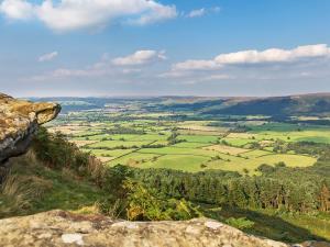 a view of a valley from the top of a mountain at Blacksmiths Cottage in Gillamoor