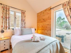 a bedroom with a bed and a large window at The Lodge in Kirk Ireton