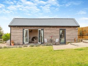 a small wooden house with a yard at The Lodge in Kirk Ireton