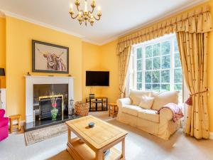 a living room with a couch and a fireplace at Manor Farm House - Uk45276 in Sculthorpe