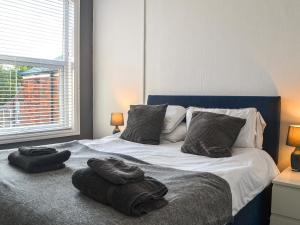 a bedroom with a bed with two towels on it at Whittles Apartment in Hornsea