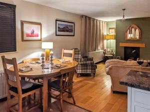 a living room with a table and a couch at Fell View House in Kendal