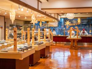 a restaurant with a row of tables in a room at Hotel Ichinose in Yamanouchi +63 photos