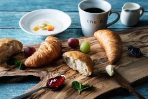 a wooden tray with bread and croissants and a cup of coffee at the b osaka-shinsekai in Osaka