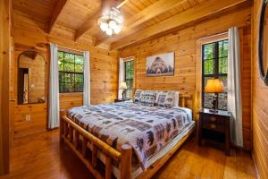 a bedroom with a bed in a log cabin at Great Smoky Mountains Cabin!, Secluded, Pet-Kid Friendly! in Sevierville