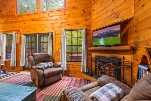 a living room with a fireplace and a tv at Great Smoky Mountains Cabin!, Secluded, Pet-Kid Friendly! in Sevierville