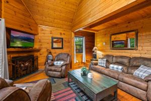 a living room with couches and a fireplace in a cabin at Great Smoky Mountains Cabin!, Secluded, Pet-Kid Friendly! in Sevierville