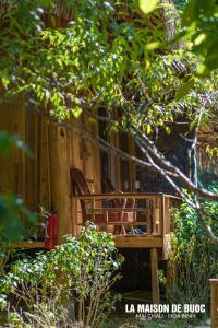 a wooden bench sitting in front of a fence at La Maison De Buoc in Mai Chau