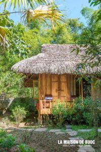 a small hut with a straw roof at La Maison De Buoc in Mai Châu