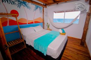 a bedroom with a bed in a room with the ocean at Solarium Beach Club in Playa Blanca