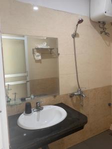 a bathroom with a white sink and a shower at Khách Sạn Phương Thuý in Yen Bai