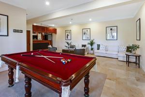 a pool table in the middle of a living room at The Golden Whistler Montville in Montville