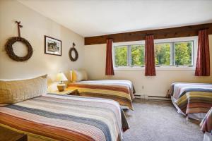a hotel room with two beds and a window at Ski home on the trail from Showshed! Or take the free shuttle A2 in Killington