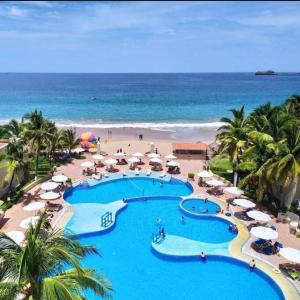 a view of a resort with a pool and a beach at departamento en ixtapa 514 in Ixtapa