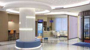 eine Lobby mit einer Säule in einem Gebäude in der Unterkunft Holiday Inn Express Dandong City Center, an IHG Hotel in Dandong