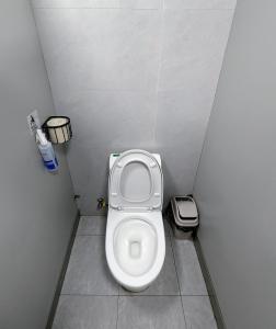 a small bathroom with a toilet in a stall at Meow! Marcia Youth Hostel in Pingtan