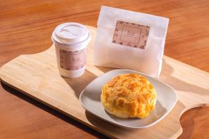 um prato com um muffin e uma chávena de café numa bandeja em Starphire Hotel em Hong Kong