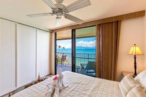 a bedroom with a bed with a view of the ocean at Hololani A404- Ocean views from every room, 2 bedroom condo in Kahana