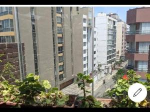 a view of a city street with tall buildings at Espacioso departamento in Lima