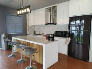 a kitchen with a counter and two bar stools at Home in Bacolod in Bacolod