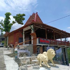 a statue of two lions in front of a building at Omah Singo Stay and Resto in Bantul