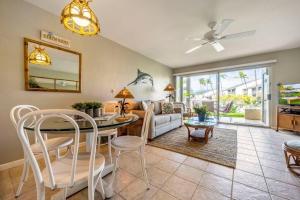 a living room with a table and chairs and a couch at Hale Kamaole 7-169- Ground floor, ocean view, updated Kihei gem in Wailea