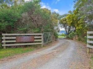 a dirt road with a fence on the side at Great Ocean Road Wellness and Nature Stay in Apollo Bay