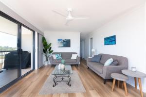 a living room with a couch and a table at Edgewater 1 - LJHooker Yamba in Yamba