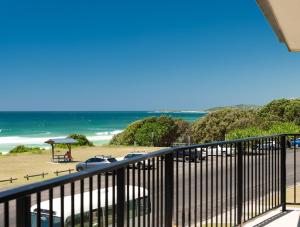 a balcony with a view of a beach and the ocean at Edgewater 1 - LJHooker Yamba in Yamba