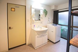 a bathroom with a sink and a mirror at -九条竹海- 和風丸々貸切一軒家 ベッドルーム3つ トイレ2つ 最大8人宿泊可 十条駅徒歩で5分 in Kyoto