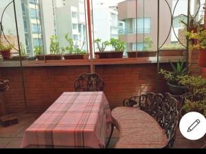 a table and two chairs sitting next to a window at Espacioso departamento in Lima