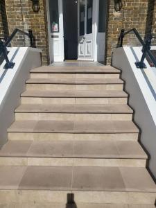 a set of stairs in front of a house at Entire South London Apartment hosted by Pius in Croydon